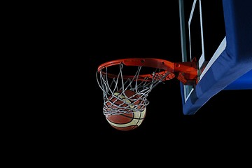 Image showing basketball ball and net on black background