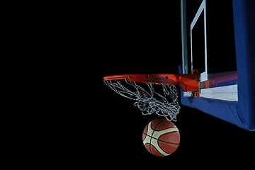 Image showing basketball ball and net on black background