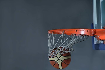 Image showing basketball ball and net on grey background