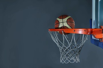 Image showing basketball ball and net on grey background