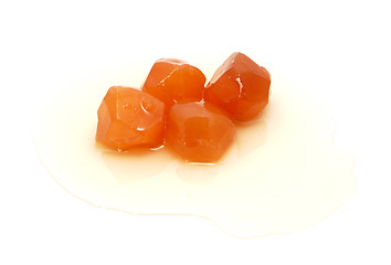 Image showing Four pieces of preserved ginger in sweet syrup