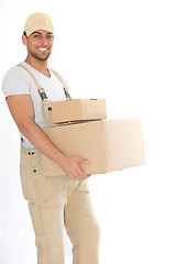 Image showing Young delivery man carrying packages