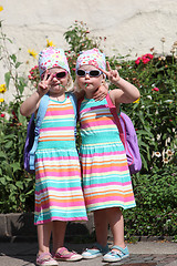 Image showing Cute little twin girls making V-signs