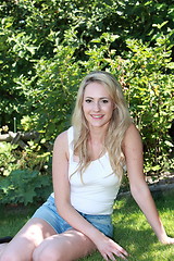 Image showing Smiling beautiful woman in the shade of a tree