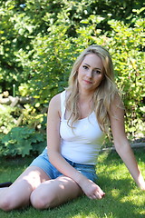 Image showing Pretty blond woman relaxing in her garden