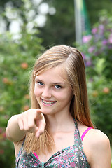 Image showing Happy teenage girl pointing at the camera