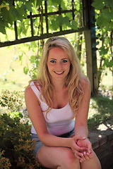 Image showing Smiling blond woman relaxing in the shade