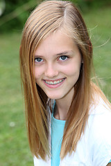 Image showing Smiling teenage girl with braces on her teeth