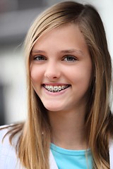 Image showing Smiling teenage girl wearing dental braces