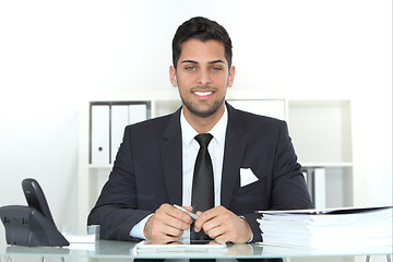 Image showing Confident successful businessman at his desk