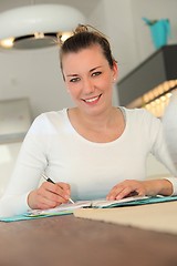 Image showing Attractive young woman working at home