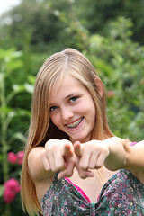 Image showing Young woman pointing her fingers at the camera