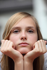 Image showing Bored young girl staring at the camera