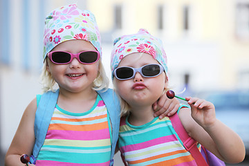 Image showing Two little identical twins in sunglasses