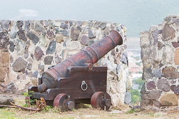 Image showing Very old rusted canon on top of an old wall