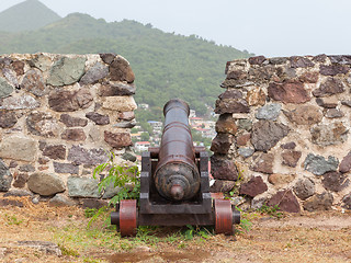 Image showing Very old rusted canon on top of an old wall