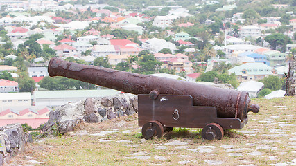 Image showing Very old rusted canon on top of an old wall