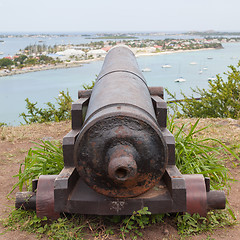 Image showing Very old rusted canon pointing at a bay