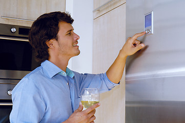 Image showing man looking on refrigerator