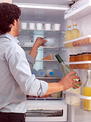 Image showing Man standing near freezer l