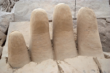 Image showing Fingers out of the sand.