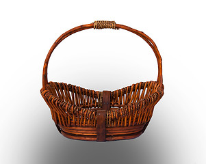 Image showing Round brown wicker basket with handle