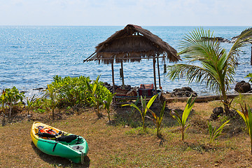 Image showing Plastic kayak on the shore next to the hut