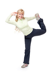 Image showing Young girl doing stretching exercises for the legs. Isolate on w