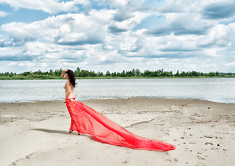 Image showing Attractive naked girl on river bank