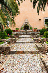 Image showing Cobbled walkway leading to a garden fountain