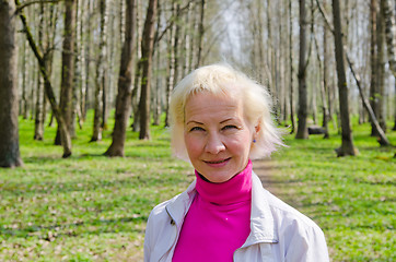 Image showing Portrait of a middle-aged woman in a spring Park  