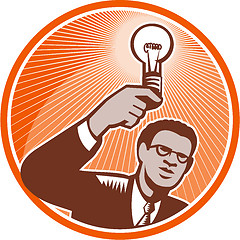 Image showing Businessman Holding Lightbulb Woodcut