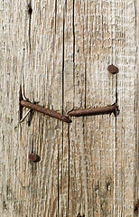 Image showing textured surface of board with a rusty nail