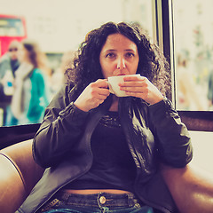 Image showing Pretty brunette drinking coffee tea