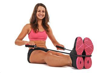 Image showing Young woman in the studio streching