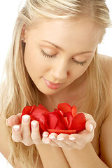 Image showing lovely blond in spa with red rose petals