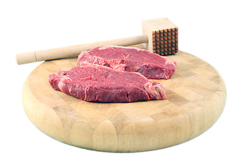 Image showing Steaks on a chopping board with Mallet