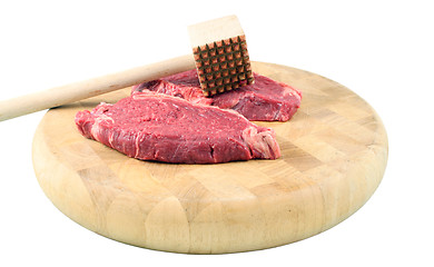 Image showing Steaks on a chopping board with Mallet