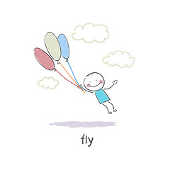 Image showing A man holding on to the balloons and flying