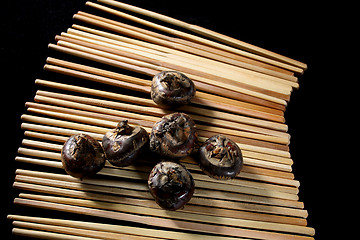 Image showing water chestnuts on chopsticks