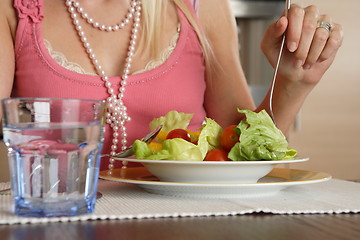 Image showing Woman eating salad