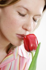 Image showing Woman smelling flower