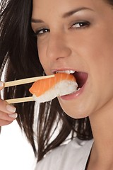 Image showing Woman eating sushi