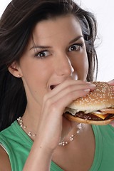 Image showing Woman eating burger