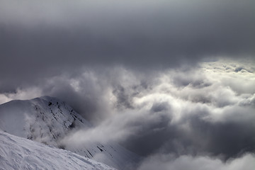 Image showing Off-piste slope and snowy rocks in bad weather