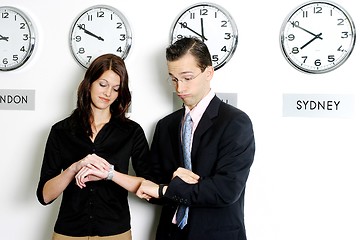 Image showing Business executives checking time