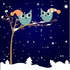 Image showing simple card illustration of two funny cartoon owls with christmas hats on a branch