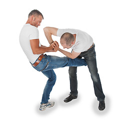 Image showing Man trying to kidnap another man, selfdefense, kicking in groin