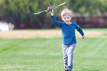 Image showing boy playing toy plane