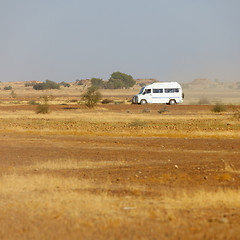 Image showing Bus carries tourists to the rocky desert. India
